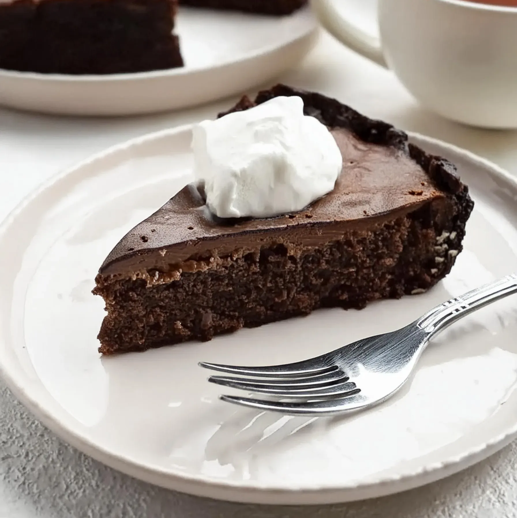 A slice of Mississippi Mud Pie with layers of chocolate filling,